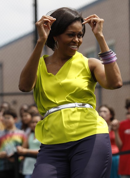 First lady Michelle Obama dances during a surprise visit to Alice Deal Middle School for a Let's Move fitness event in Washington