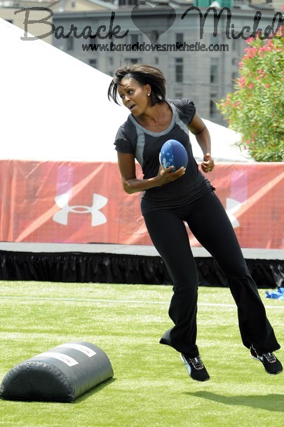 U.S. first lady Obama performs some football drills before playing flag football during her "Let's Move" campaign to fight childhood obesity in New Orleans